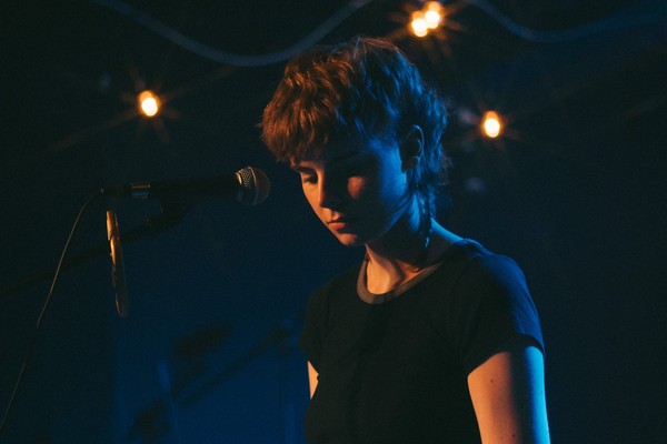 On-stage portrait of Michaela Gilchrist of Victrix performing.