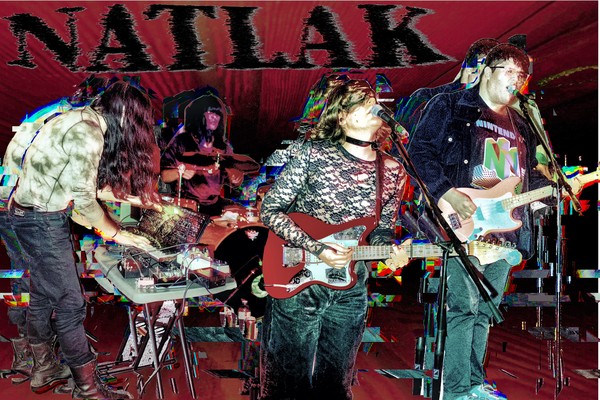Experimental action shot of NATLAK performing on stage. Image has a double exposure effect and band name "NATLAK" is written in a vaporizing font.