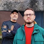 Outdoor portrait of duo CHXMERAS looking toward the camera.