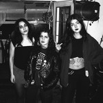 Indoor black and white portrait of trio MUÑECA standing and facing the camera