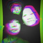 A distorted photo shows three-piece band DMBQ with their heads pushed with a purple and green colour effect on top. 