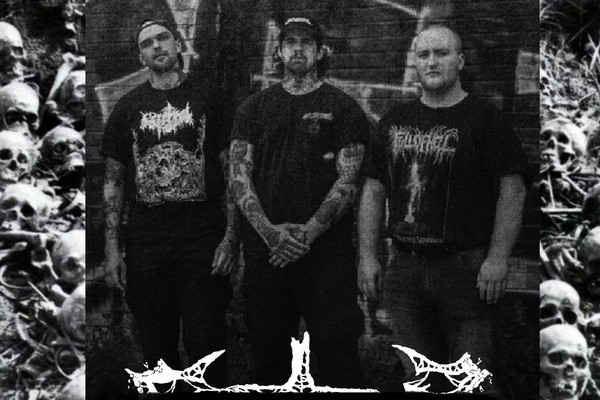 A grainy black and white photo shows three-piece Feartilizer 1492 standing against a dark brick wall with graffiti on it. Outside of the frame of the photo, skulls and bones can be seen in the background.