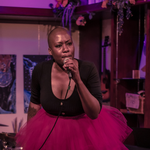 Portrait of solo artist A.N singing into a microphone, performing at Alcove Music & Arts Centre.