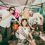 Four-piece Bad bodies are positioned on the eighty-eight patio, smiling toward the camera.