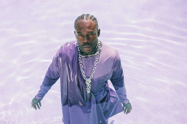 Taken from above, solo artist BAWAH (previously MAUVEY) is submerged, while draped in traditional African cloth.