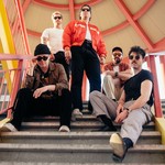 Taken from below, five-piece BETABOYS are posed on a covered set of outdoor stairs, each looking toward the camera