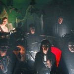 Dark and grainy image of six-piece BIG EVIL RAT looking ominously toward the camera with their instruments.