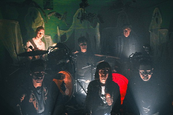 Dark and grainy image of six-piece BIG EVIL RAT looking ominously toward the camera with their instruments.