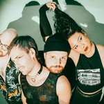 A colour photo of the four members of Chinese Medicine posed closely together against a green background with dramatic lighting casting strong shadows. One member with long black hair lifts it above their head. One member is wearing a black toque. Another wears a mesh tank top and choker necklace, while another member in glasses and a tropical shirt looks upward.