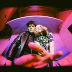 Taken from below, vibrant photo of duo Diamond Day looking down toward the camera