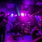 A colour photo shows five-piece band Everythingyoueverloved on a stage lit with purple lights .