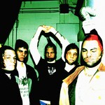 An over exposed colour photo shows the five-piece band Hillboro standing in a room all with pantyhose over their faces.