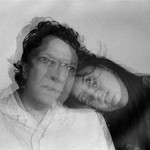 A blurry black and white photo shows the duo Ribbon Skirt. The member on the left rests their head on the shoulder on the member on the left