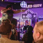Hip-hop artist Tanajah is seen in a colour photo holding the microphone out to the audience during a performance at the Ship and Anchor