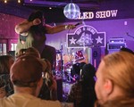 Hip-hop artist Tanajah is seen in a colour photo holding the microphone out to the audience during a performance at the Ship and Anchor