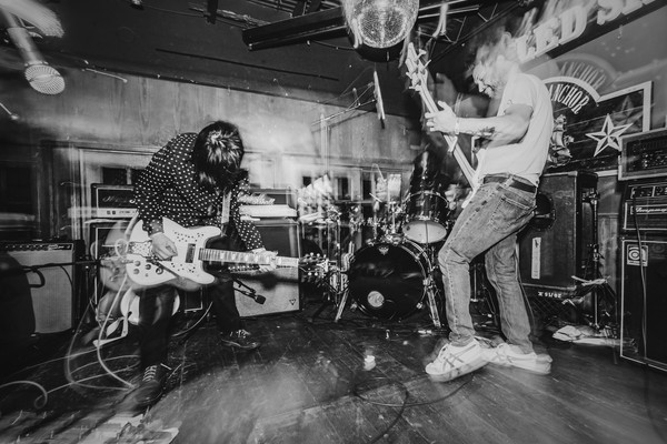 A black and white photo shows three-piece Tebby & the Heavy playing on stage at the Ship and Anchor.