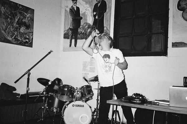 Solo artist The Furnace is shown in black and white singing into a microphone standing next to a drumkit.
