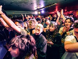 Photo of a cheering crowd in the basement of the Palomino. Taken at Sled island 2024.