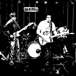 Black and white photo of Tha Retail Simps performing on stage