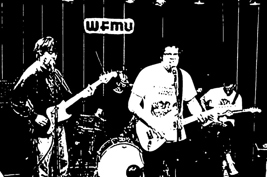 Black and white photo of Tha Retail Simps performing on stage