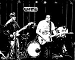 Black and white photo of Tha Retail Simps performing on stage