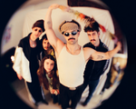 Shot with a fish eye effect, photo of five-piece Pastel Blank posed in a room, facing the camera.