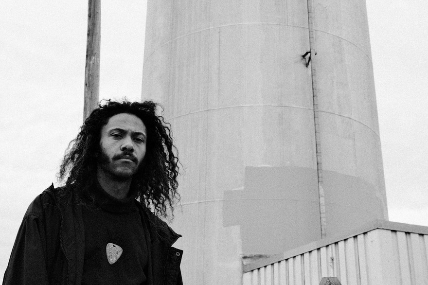 Black and white photo of solo musician Jairus Sharif