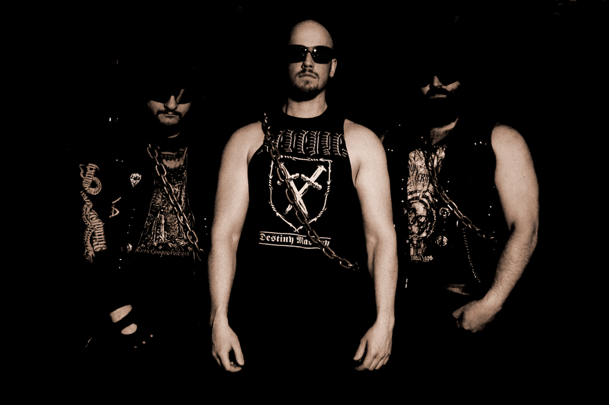 Sepia photo of trio Suffering Hour standing posed toward the camera, each are wearing a chain sash