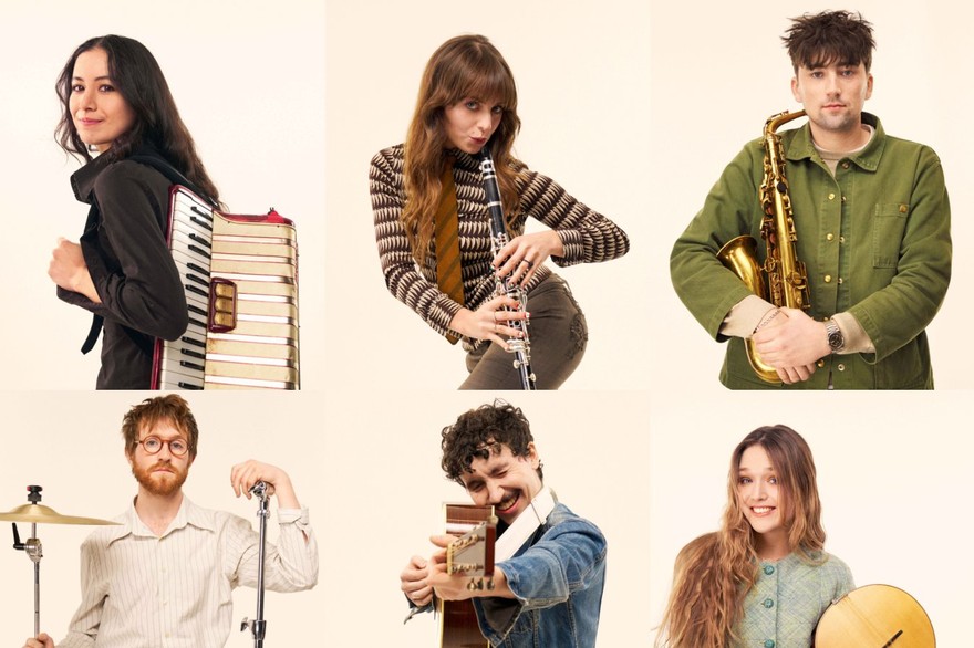 Black Country, New Road in a 3×2 grid of portraits, each holding their instrument against a pale studio backdrop. Their neutral expressions and simple staging give the image a quiet, art‑school formality reminiscent of Black Country, New Road’s visual style.