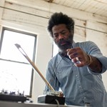 Photo of experimental artist Robert Aiki Aubrey Lowe, captured in motion.