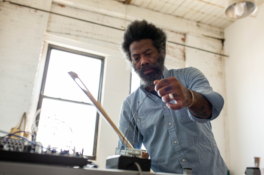 Photo of experimental artist Robert Aiki Aubrey Lowe, captured in motion.