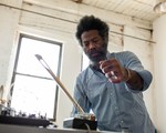 Photo of experimental artist Robert Aiki Aubrey Lowe, captured in motion.