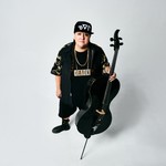 Photo shot from above of Chris Derksen holding a cello, looking up toward the camera.