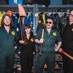 A colour photo shows four-piece band Brain Bent standing in a maintenace closet wearing matching jump suits, each of them holding tools like axes and sledgehammers. 