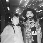 A black and white photo shows duo MOONBEAN standing in an underground train station looking at the camera. 