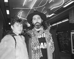 A black and white photo shows duo MOONBEAN standing in an underground train station looking at the camera. 