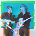 A colour photo with a distorted red and blue 3D type effect shows two members of the band Temps standing side by side wearing all black and both holding white guitars.