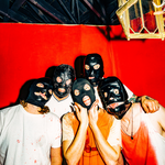 Five members of Tear Dungeon stand close together in front of a vivid red backdrop, each wearing a black mask that obscures most of their face. They’re dressed in casual shirts—some splattered or stained—and lit brightly against the intense background, creating a stark, unsettling group portrait.